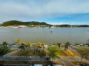 a view of a large body of water with palm trees at Nhà Nghỉ M91 in Ha Tien