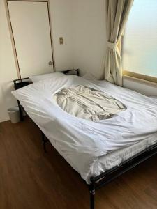 Postel nebo postele na pokoji v ubytování メゾンジョイ久須志#305