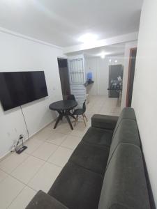 a living room with a couch and a table at Apartamento para São João in Campina Grande