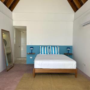 een slaapkamer met een bed met blauw en wit bij Las casitas del norte in Zorritos