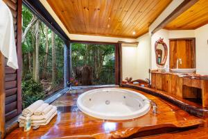 a bathroom with a tub and a large window at Secrets on the Lake in Montville