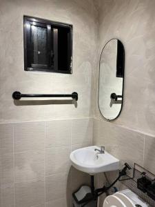a white bathroom with a sink and a mirror at 2BR Home in Davao in Davao City