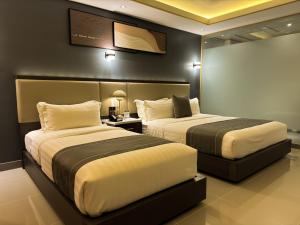 Ένα ή περισσότερα κρεβάτια σε δωμάτιο στο Subic Riviera Hotel & Residences +14 φωτογραφίες