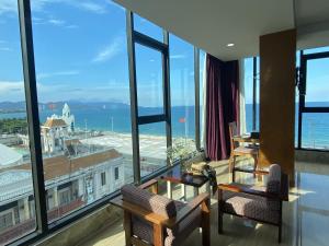 a room with a large window with a view of the city at Happy Light Central Nha Trang in Nha Trang