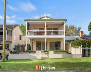 a house with a porch and a balcony at The Moorings in Iluka