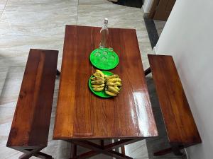 a wooden table with a green plate of bananas on it at Hill Garden Views in Anachal