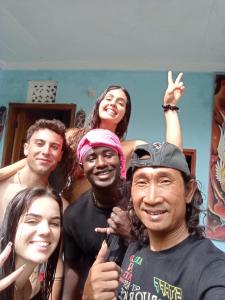 a group of people posing for a picture at ATB Hostel in Lovina