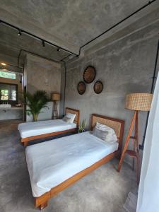 a bedroom with two beds and a lamp at Salty Prana Retreat Center in Uluwatu +71 photos