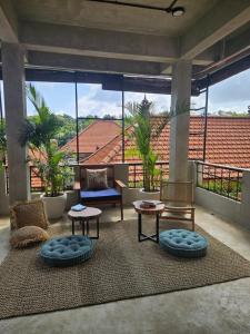 a living room with couches and tables on a patio at Salty Prana Retreat Center in Uluwatu