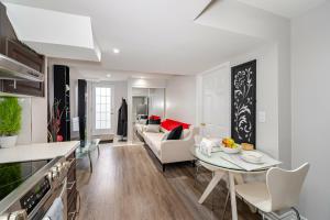 a kitchen and living room with a couch and a table at Lovely Cozy Apartment in Brampton