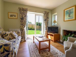 a living room with a couch and a table at Questant Lodge in Sidmouth