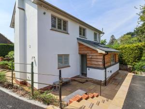 a large white house with a wooden building at Questant Lodge in Sidmouth