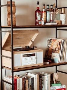 a book shelf with a microwave and books at Chic Bohemian Hideaway in Umdloti
