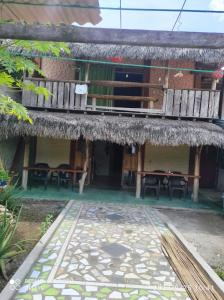 an outside view of a building with a table and chairs at Mi Cabaña El Maderal in Capurganá