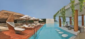 a rendering of a pool with chairs and tables at Chi Samui Resort in Bophut