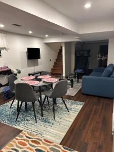 a living room with a table and chairs and a couch at Beautiful Lower level 2 bedroom aprt in Toronto