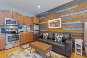 Una sala de estar con un sofá y una cocina. en Prospector Lodge #503, en Park City
