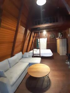 a living room with a couch and a table at Pondok Wisata Eco village Malagufuk in Sorong +8 photos