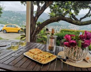 a table with a plate of food and glasses of wine at Villa Venino in Moneglia
