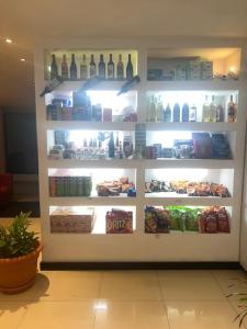 a refrigerator filled with lots of food and drinks at Golden Tree Hotel Belize in Belize City