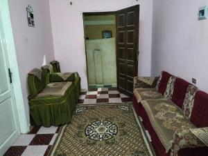 a living room with two couches and a door at مدينة القصير in Quseir