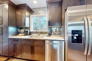 a kitchen with wooden cabinets and a stainless steel refrigerator at Hog Heaven in Fayetteville