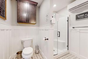 a white bathroom with a toilet and a shower at Hog Heaven in Fayetteville +30 photos