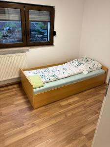 a small bed in a room with a window at Das Rosenhaus in Hargesheim in Hargesheim