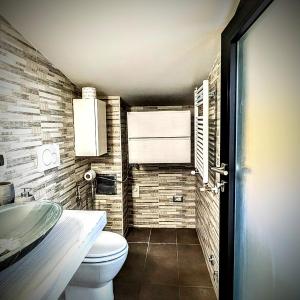 a bathroom with a toilet and a sink at Solaris Guest House in Ciampino +19 photos