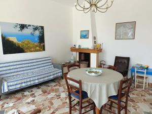 a dining room with a table and chairs at La terrazza sul mare - Marina di Novaglie in Alessano