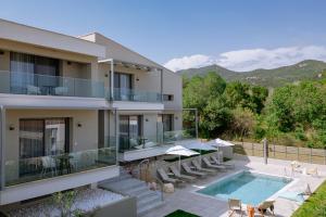 an image of a house with a swimming pool at Arodo Suites in Iraklitsa