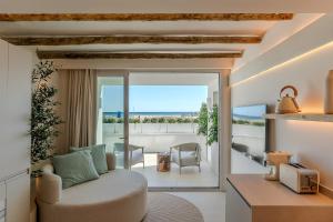 a living room with a couch and a view of the ocean at Apartamentos Azul in Castelldefels