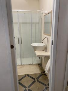 Un baño con lavabo y ducha con espejo. en Antica casa, en Vernole 25 fotos más
