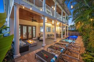 an indoor patio with a swimming pool and a house at Florida Keys Villa Beach Proximity Heated Pool Serenity at its Finest Hemingway Key VlLLAS in Fort Lauderdale
