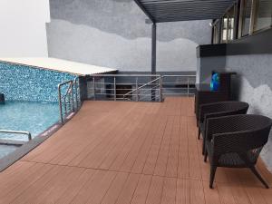 a balcony with chairs next to a swimming pool at Fortune Park, Tiruppur - Member ITC Hotels' Group in Tiruppūr