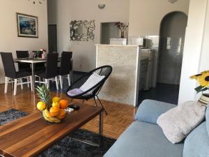 uma sala de estar com uma mesa com uma taça de fruta em Apartment Frane Podstrana with private pool em Podstrana