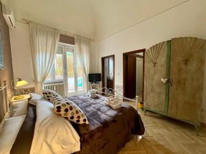 Postel nebo postele na pokoji v ubytování Aedes B&B Il Giardino dei Sogni