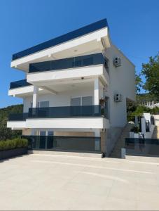 a white building with blue balconies on the side at The View - Sabrina Premium Villa in Brca