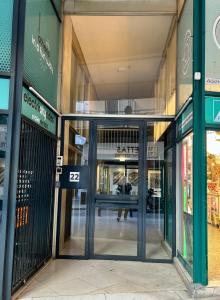 an entrance to a shopping mall with revolving doors at JV Athens in Athens