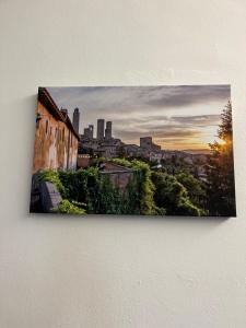 a painting of a city skyline on a wall at La Casina di Cinzia in San Gimignano
