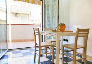 a table and chairs in a room with a window at Holihome_Ludi - Bilocale vicino al mare in Alba Adriatica
