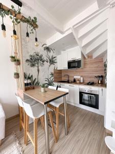 uma cozinha e sala de jantar com mesa e cadeiras em La petite M em Tréméreuc