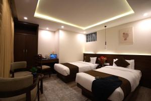 Tempat tidur dalam kamar di Apex Business Hotel - Tribhuvan International Airport, Kathmandu