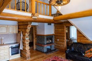 a living room with a staircase and a fireplace at Lambievi Kolibi in Gorno Kraishte
