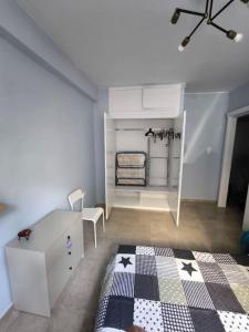 a room with a room with a table and a rug at Apartment 50 meters from the beach in Loutraki