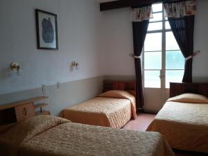 Postel nebo postele na pokoji v ubytování Hotel Centenario