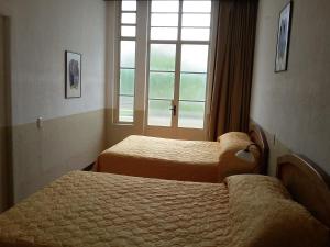 A bed or beds in a room at Hotel Centenario