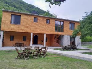 a building with tables and chairs in front of it at xhovani zelna in Theth