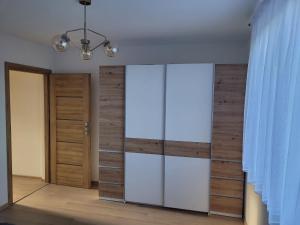 a room with a glass partition and a door at Apartament u Jędrusia I in Żywiec