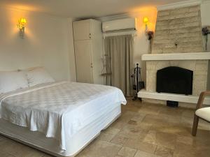 a bedroom with a white bed and a fireplace at 8 oDa Marmaris in Marmaris